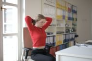 The chair twist is a great chair exercise for your back and lower body. (Image via pexels/Andrea Piacquadio)